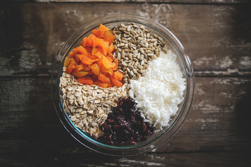 Homemade granola with dried apricots, cranberries, coconut, sunflower seeds, and oatmeal