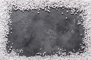 White polystyrene balls on grey  background