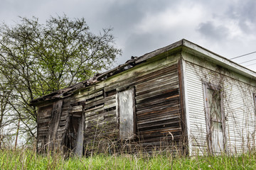 Old abandoned shed in a grassy field