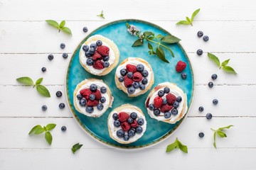 Homemade millefeuille with berries and fresh mint leaves, top view.