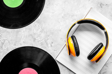 Workplace of DJ. Vinyl records, headphones, music notes on grey background top view