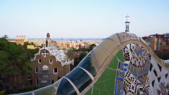 Gaudi mosaic bench and cityscape of Barcelona from park Guell, famous view of Barcelona, Spain, toned