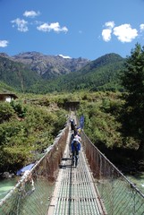 Trekking over a Bridge in Bhutan