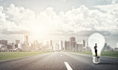 Businesswoman inside light bulb