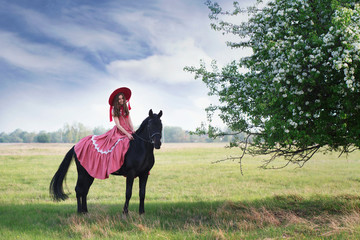 Beautiful princess in pink dress with friend horse Grom © danissimo1992