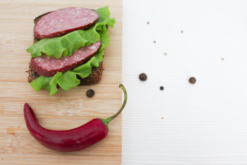 a sausage sandwich on a cutting board
