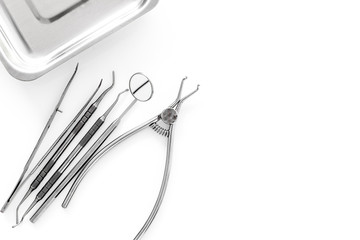 Set of dentists tools near cuvette on white background  top view copyspace