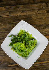 Green ravioli with spinach on a wooden background with copy space. top view
