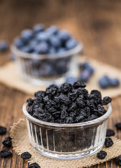Dried Blueberries on wooden background; selective focus