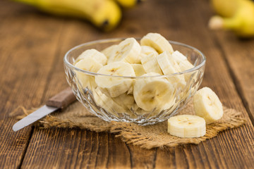 Wooden table with Sliced Bananas, selective focus