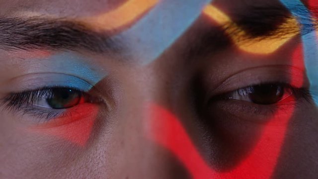  Close up colorful patterns of light projected onto face of attractive model