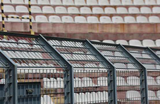 metal fence in the stadium to divide the fans on the pitches fro