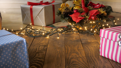 Beautiful Christmas background with lights, gifts and Christmas tree on wooden flory. Copy space for your text or design