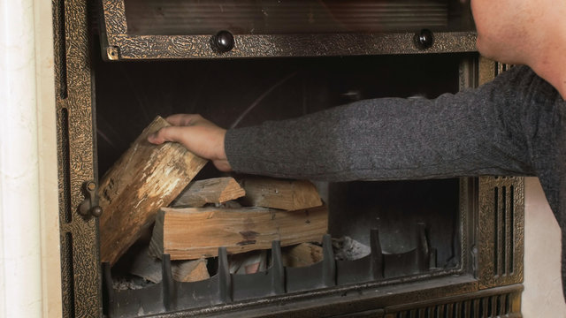 Closeup shot of man preparing fireplace