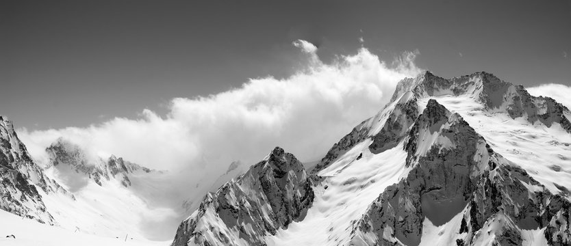 Black and white panoramic view on snow mountains