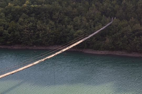 Albania: Decaying Hanging or suspension bridge with loose wires and broken wooden planks