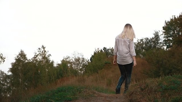 the girl goes along the path 