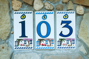 Fototapeta premium house number from ceramic tiles on the wall