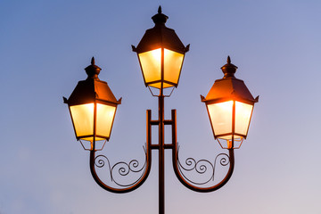 Fototapeta na wymiar glowing street lamp against the sky