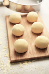 Fototapeta na wymiar Dough balls for making tortillas on kitchen table