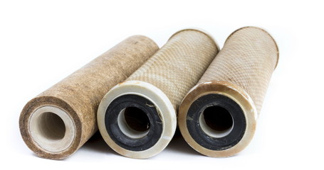Dirty water filter cartridges on white background