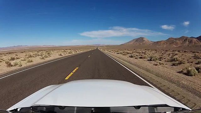 Fast drive on straight road through desert