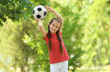 Cute girl with soccer ball in park