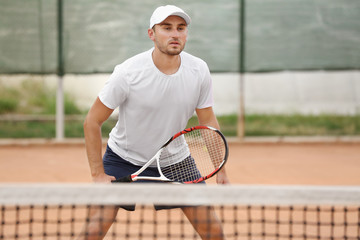 Young man playing tennis on court