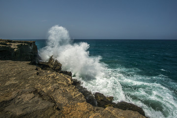 Rock in the surf with very high waves