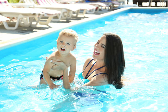 Baby with mother in swimming pool