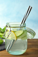 Jar with detox infused cucumber water on table