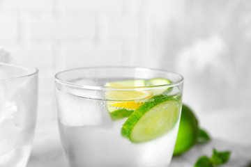 Delicious refreshing water with cucumber in glass, close up