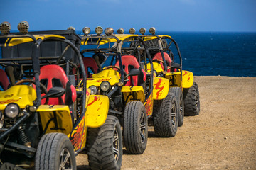 yellow beach buggies without driver in background the blue sea - 174348418