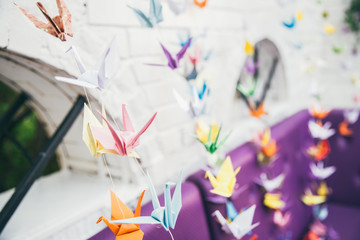 Colorful many origami paper cranes on white background