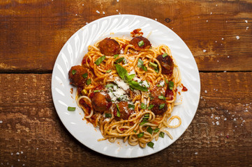Spaghetti pasta with meatballs and tomato sauce, top view