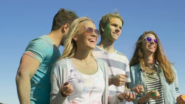 Multi-Ethnic Group of Diverse Young People Dancing in Celebration of Holi Festival. They Have Enormous Fun on this Sunny Day. Shot on RED EPIC-W 8K Helium Cinema Camera.