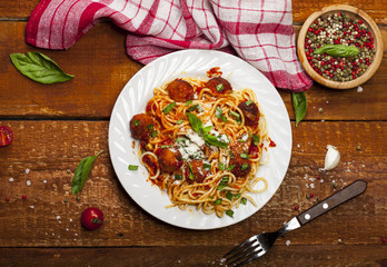 Spaghetti pasta with meatballs and tomato sauce, top view