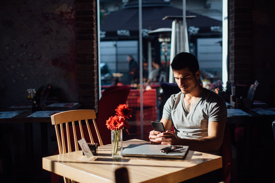 Man using a laptop in a cafe