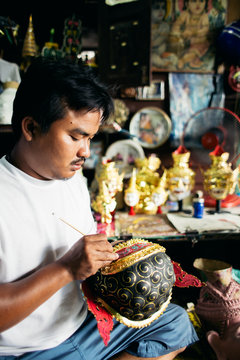 Local artist painting 'Hua Khon' traditional mask for Thai performing arts