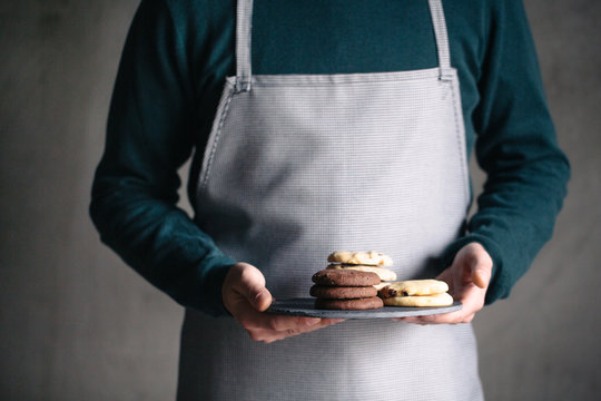 Man in an Apron Holding Cookies