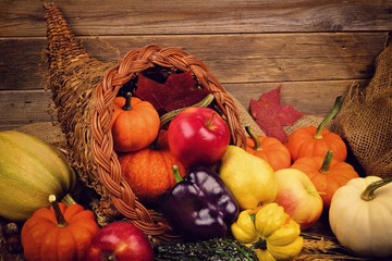 Thanksgiving cornucopia close up against a rustic wooden background