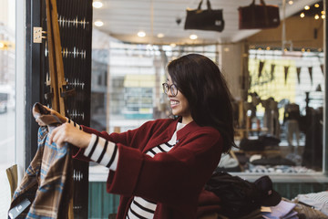 Smiling woman shopping in downtown boutique