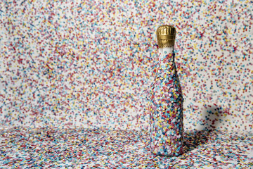 Champagne bottle covered with confetti