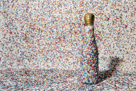 Champagne bottle covered with confetti