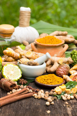 Turmeric powder,Turmeric in Mortar Grinder drugs and ingredient herbs on wooden background