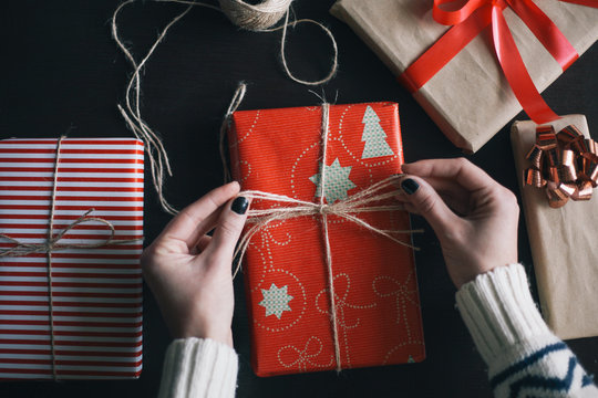 Female hands wrapping Christmas presents
