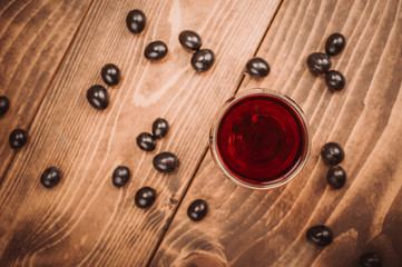 Glass of red wine and grapes on rustic wood table