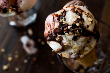 ice cream in glass with chocolate sauce and hazelnut.