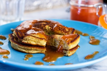 Close up on stack of homemade gluten free pancakes with peach jam