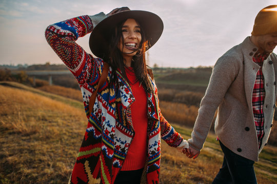 Couple spending day in nature, walking on sunny autumn day
